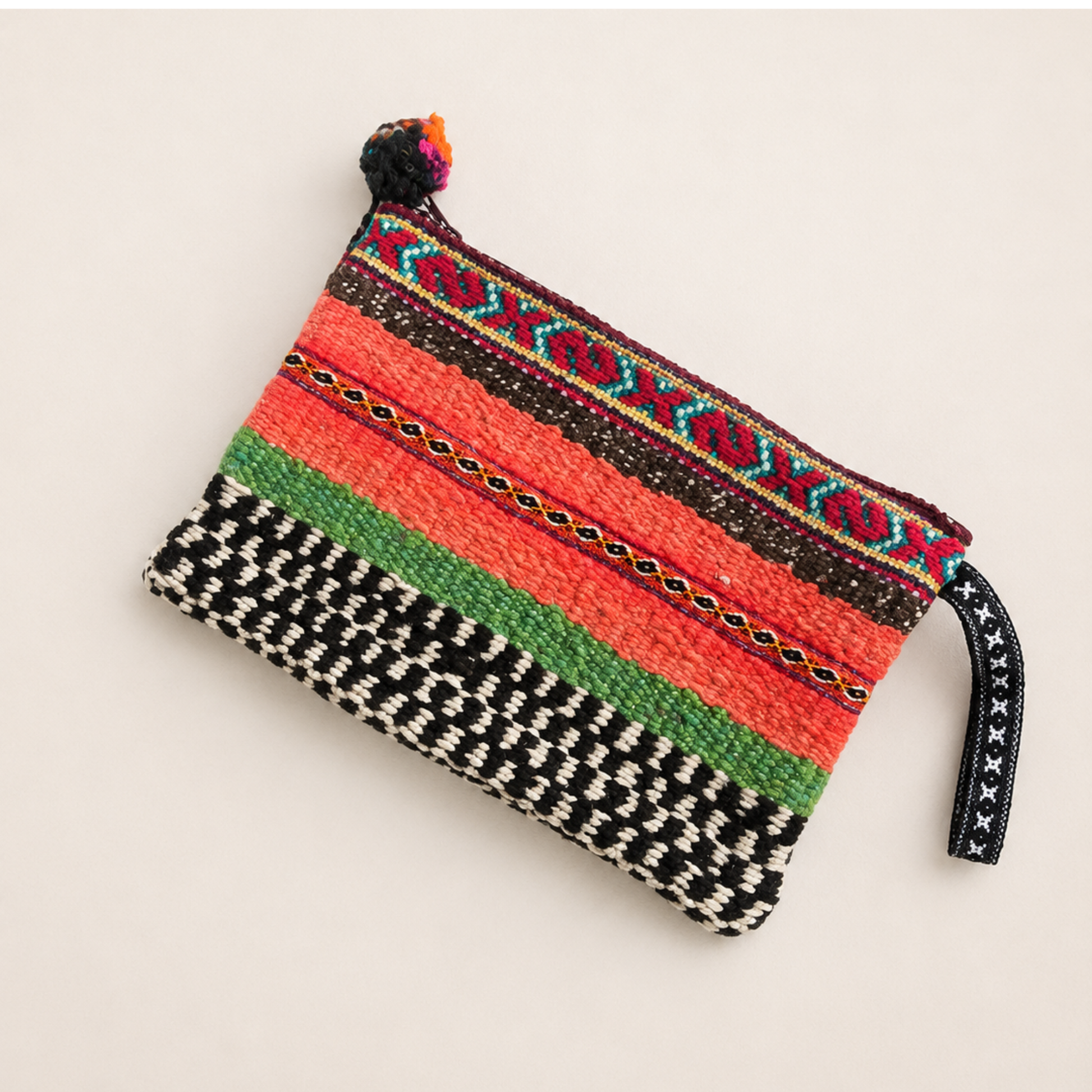 Handmade purple Peruvian pouch with traditional woven pattern.