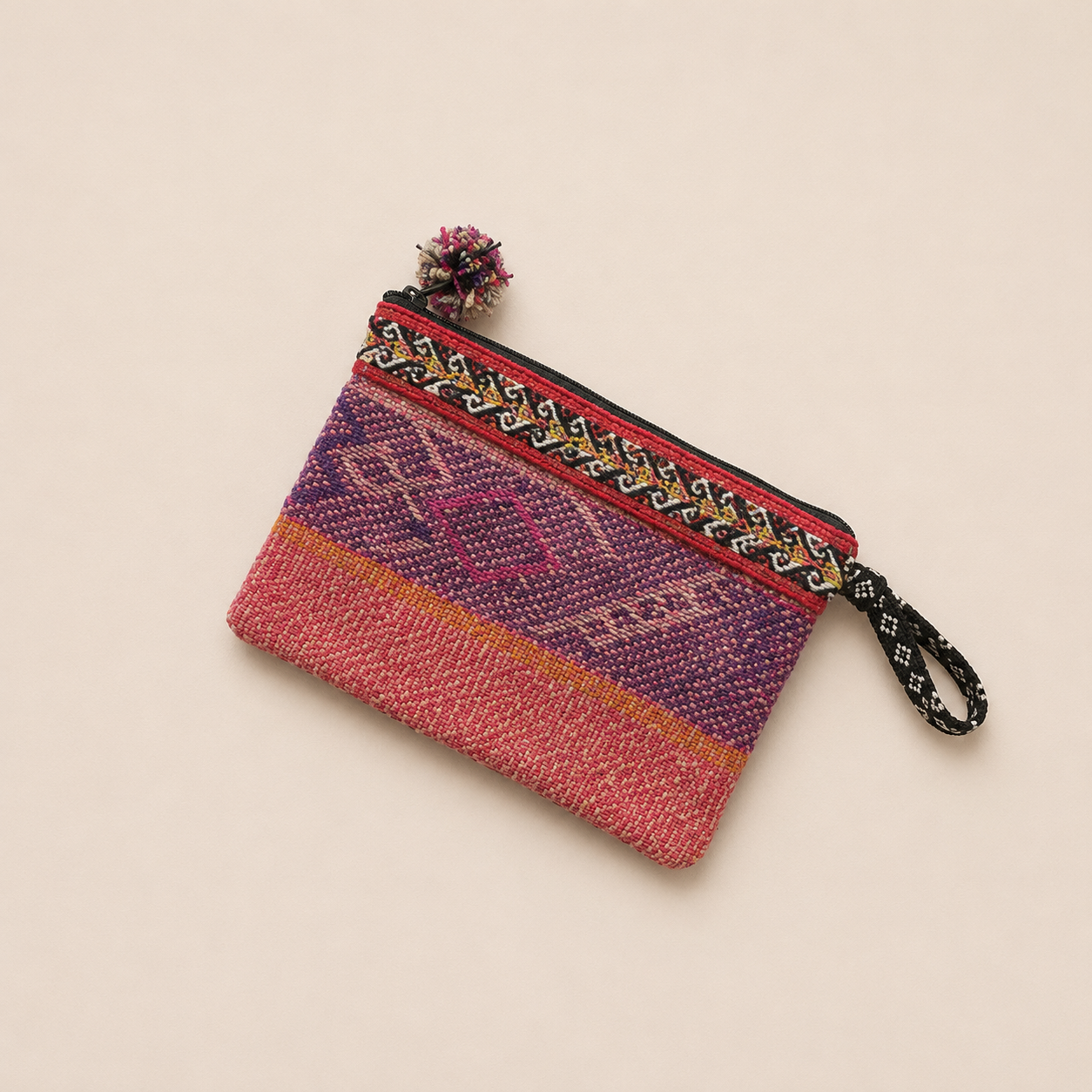 Handmade pink woven pouch with colourful Andean stripes.