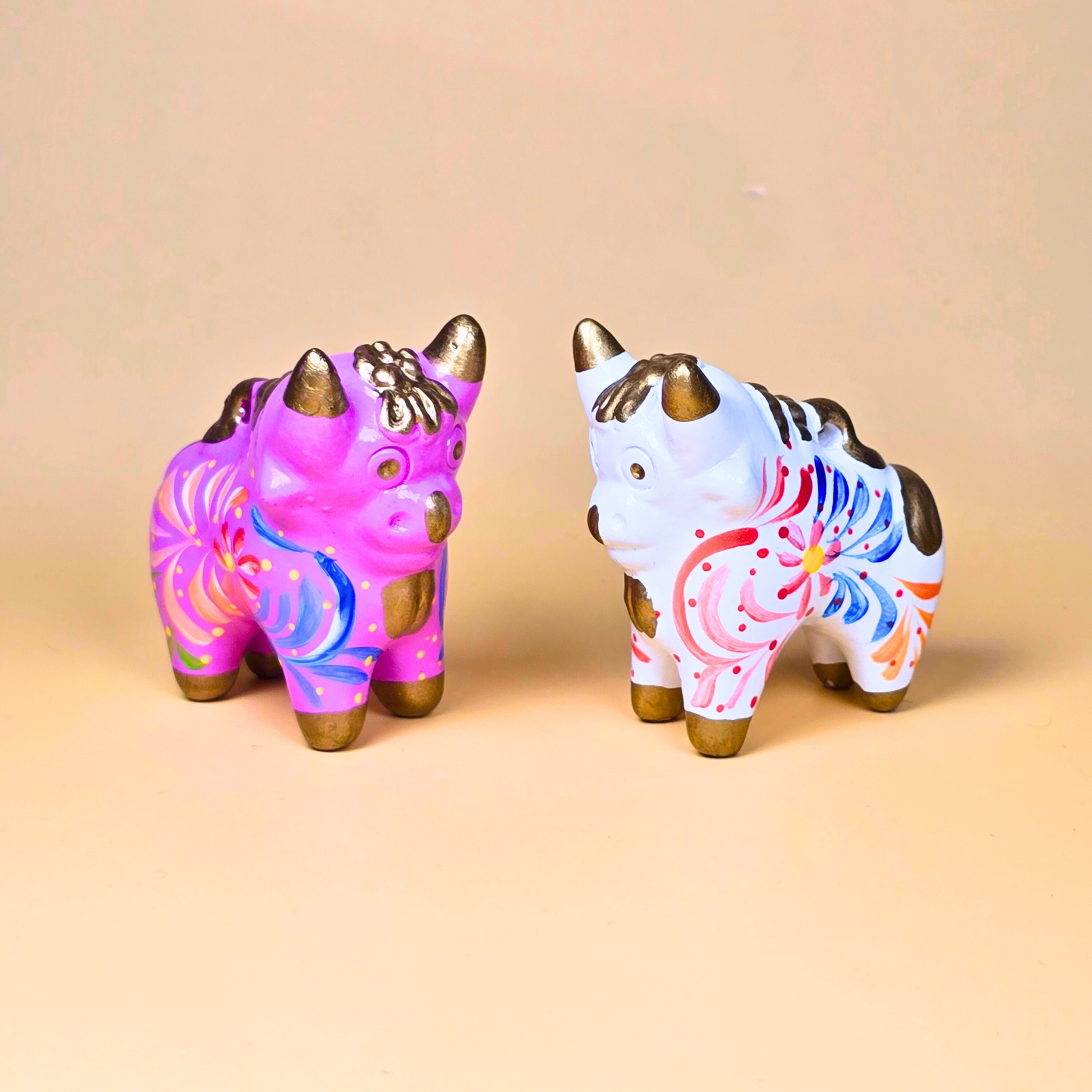 Pink and white hand-painted Torito de Pucará ceramic bulls