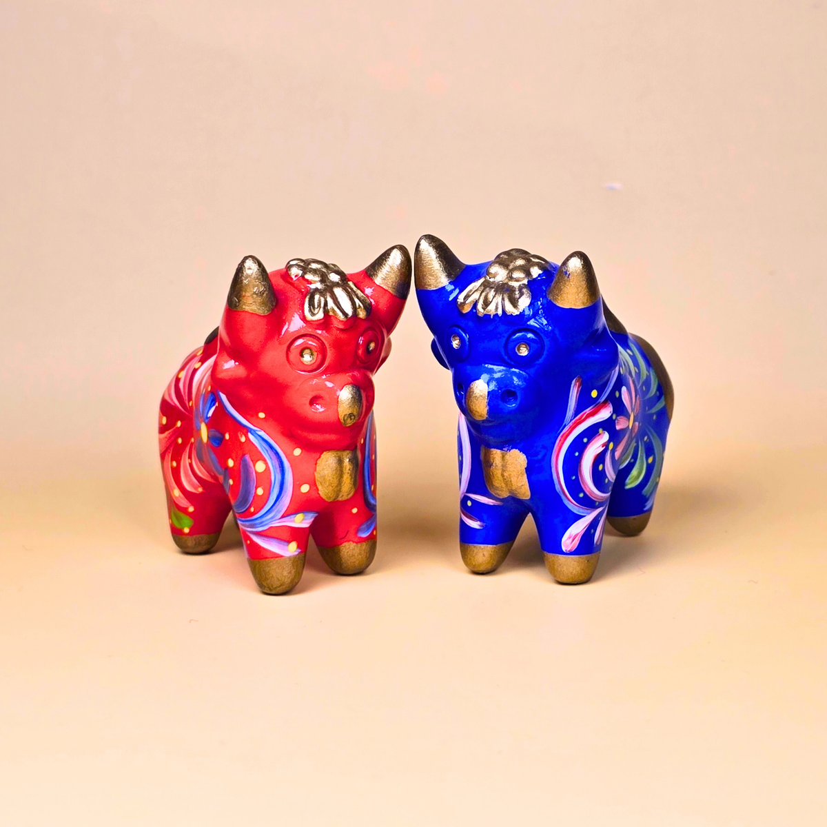 Red and blue Torito de Pucará handmade ceramic bulls from Peru