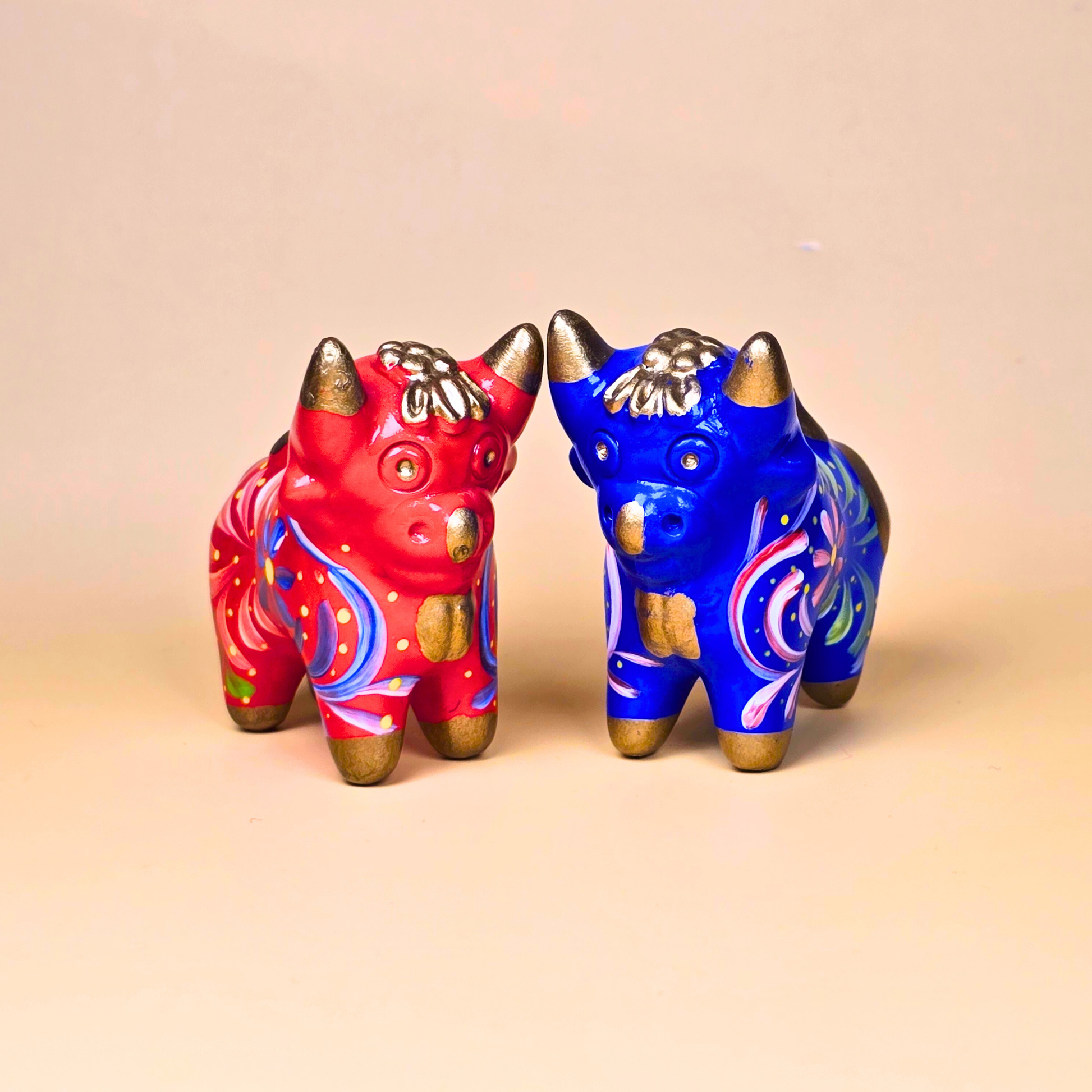 Red and blue Torito de Pucará handmade ceramic bulls from Peru
